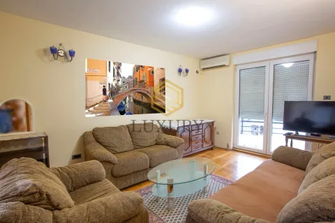 Living room with sofa seating, coffee table, and television. - image 3