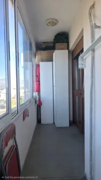 Enclosed balcony with storage cabinets and boxes. - image 9