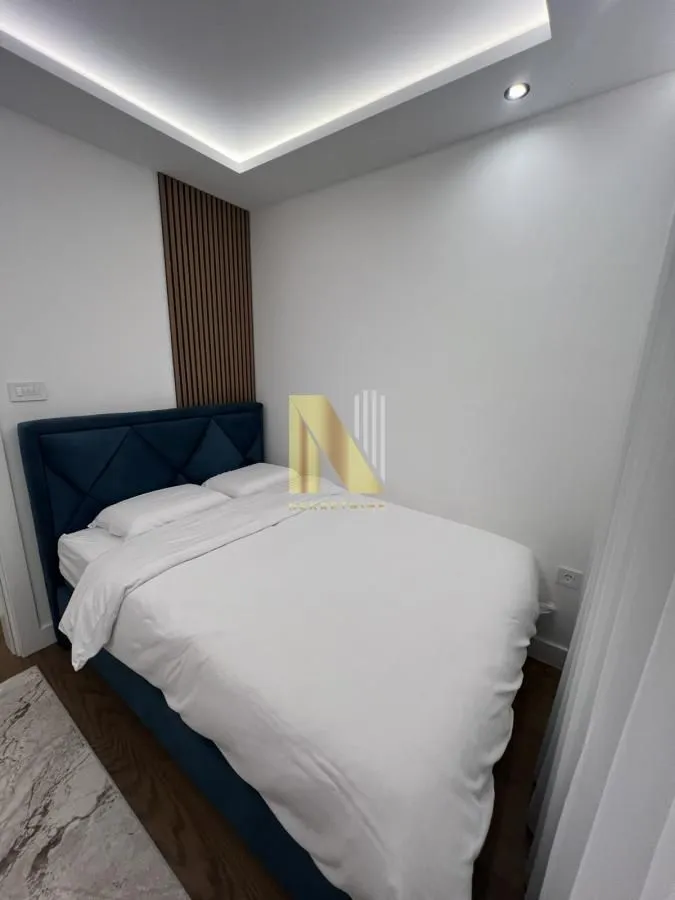 Smaller bedroom with a double bed and modern lighting.
