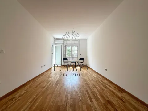 Empty room with hardwood floors and white walls. - image 2