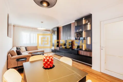 Living room with a sofa, dining table and a modern wall unit with lighting. - image 8