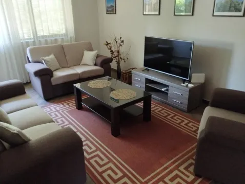 Living room with sofa set, coffee table, and TV. - image 8