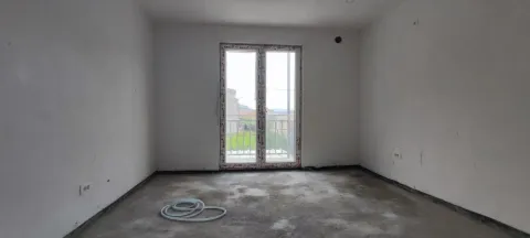 Empty room under construction with balcony doors and bare walls. - image 9