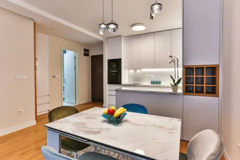 Modern and bright kitchen with a dining table. - image 8