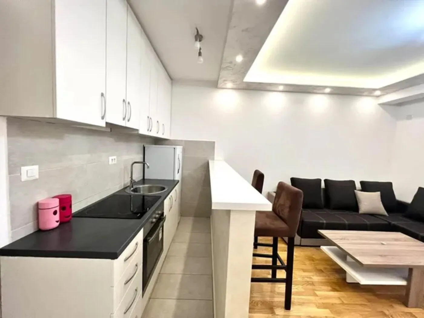 Modern kitchen with a breakfast bar integrated into the living area.