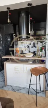 Small kitchen with a breakfast bar and a bar stool. - image 4