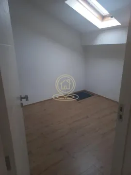 Empty room with laminate flooring and a skylight. - image 7