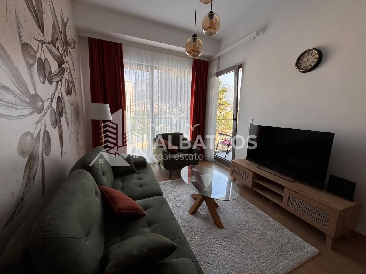 Living room with a sofa, TV, and access to the terrace.