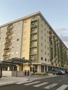 Exterior view of a modern residential building with balconies and parking. - image 5
