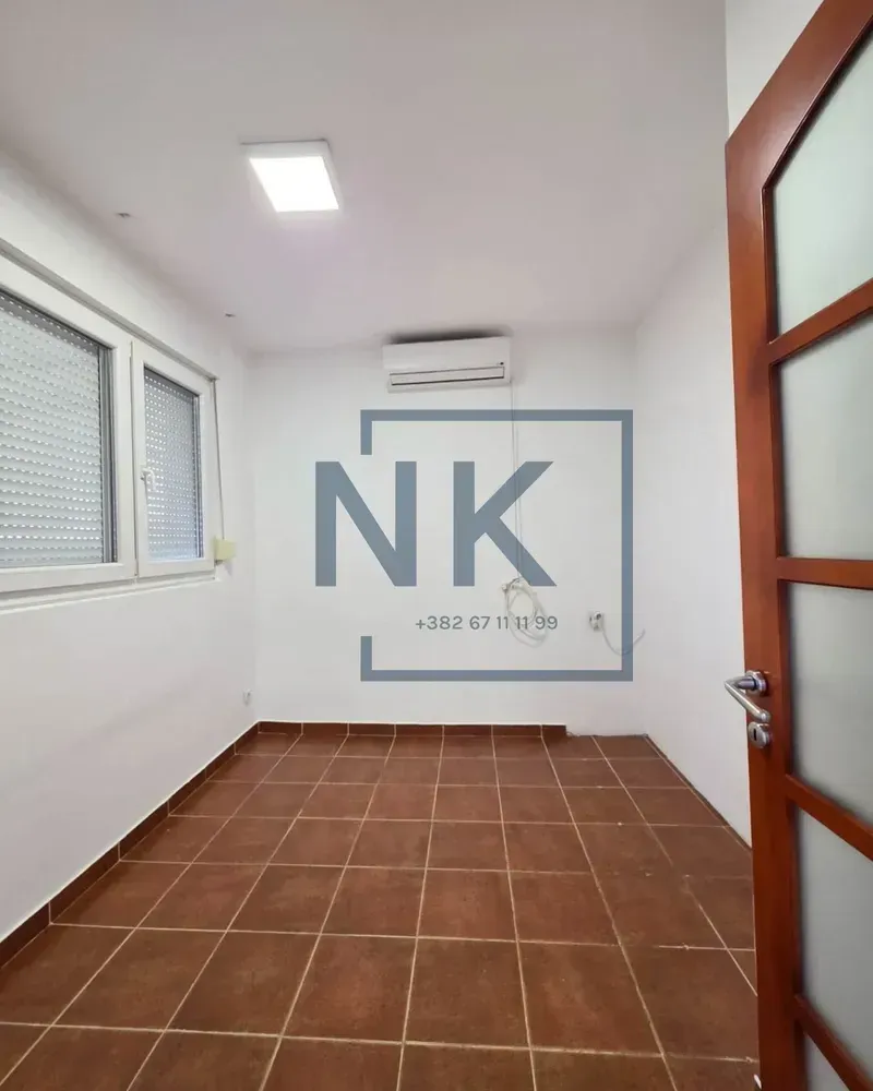Empty room with ceramic floor tiles and an air conditioner on the wall.
