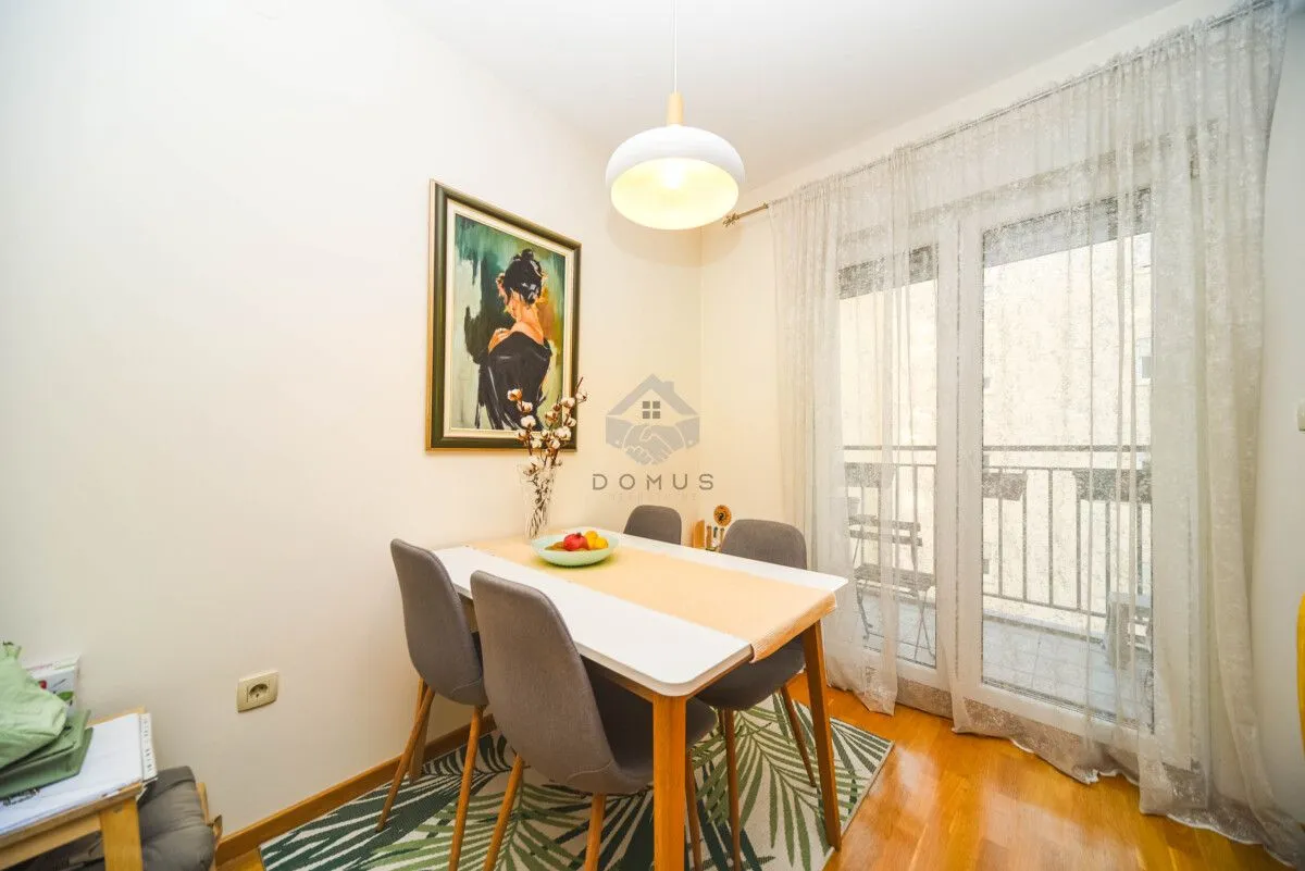 Dining area with a table, four chairs, and access to the terrace.