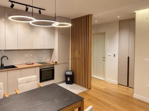Modern kitchen with built-in appliances and a dining table. - image 7