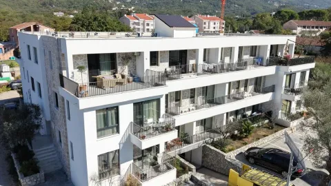 Side view of a modern multi-family residential building with balconies and parking. - image 3