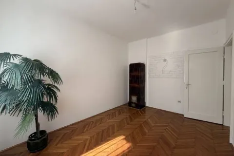 Empty room with wooden parquet flooring and a wood stove. - image 12