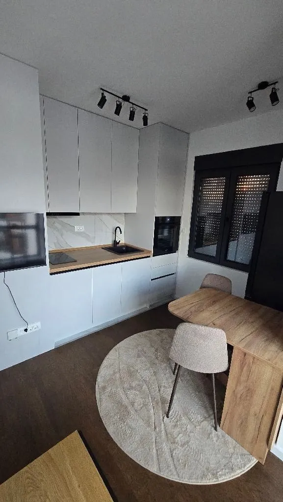 Modern kitchen with a dining table and chairs.