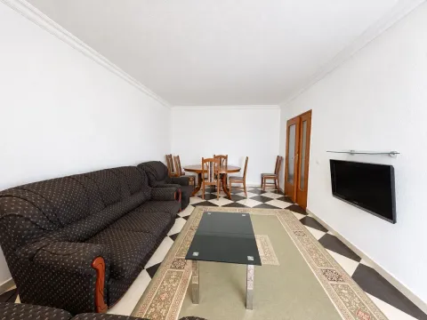 Living room with sofa set, dining table, and TV. - image 8