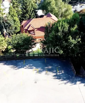 Aerial view of the house exterior with parking and greenery. - image 9