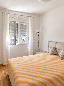 Bright bedroom with a double bed and a window. - image 6