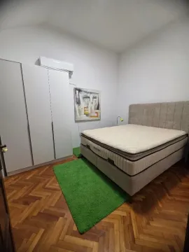 Bedroom with a double bed, wardrobe, and parquet flooring. - image 14