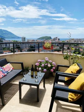 Furnished terrace with seating set and view of the city and sea. - image 4