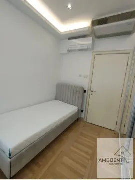 Smaller bedroom with a bed and an air conditioning unit. - image 13