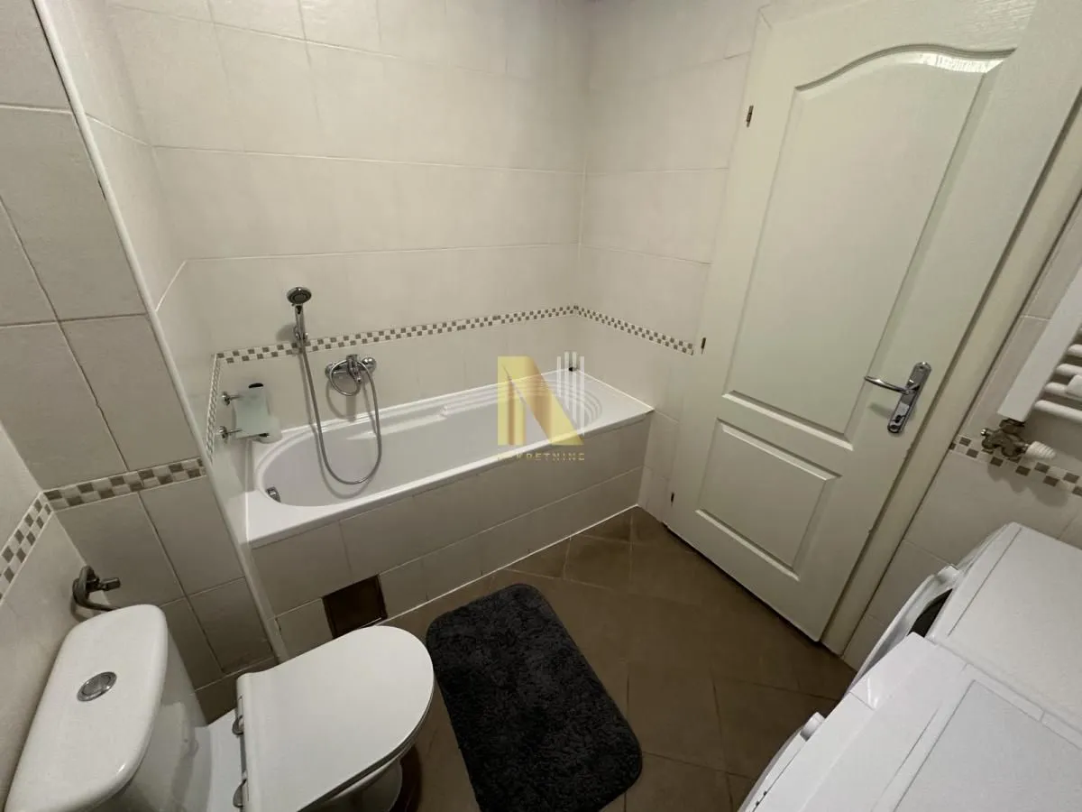 Bathroom equipped with a bathtub, sanitary ware, and wall tiles.