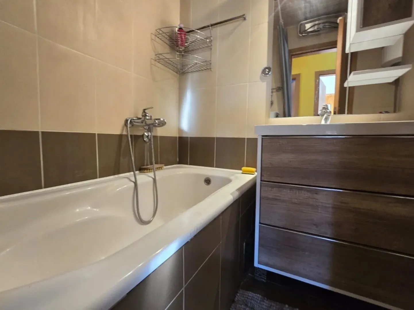 Bathroom with a bathtub and a vanity sink.