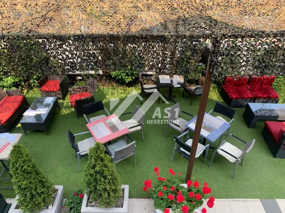 Top-down view of the terrace with seating furniture and greenery.