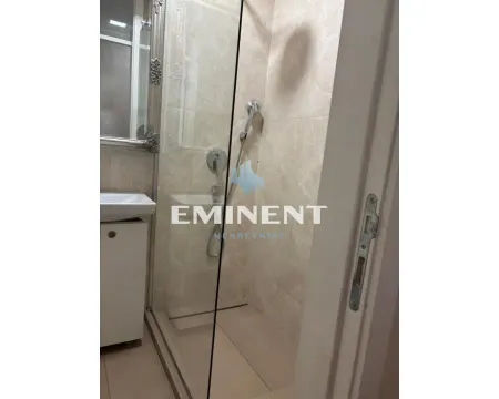 Smaller bathroom with a shower cabin and a sink. - image 10