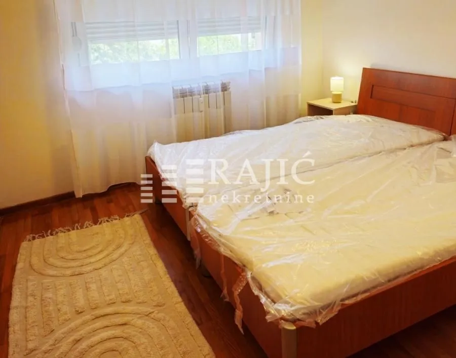 Bedroom with a double bed and wooden furniture.