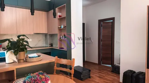 Modern kitchen with wooden elements and a dining table. - image 4