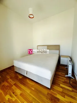 Bedroom with a double bed and wooden flooring. - image 8