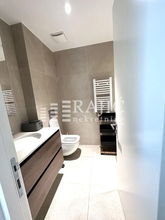 Modern bathroom with a sink and toilet.