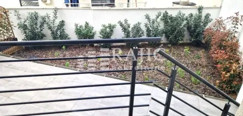 Terrace overlooking a landscaped courtyard and greenery. - image 17