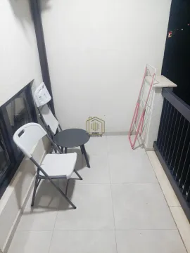 Small balcony with patio furniture and a clothes drying rack. - image 6