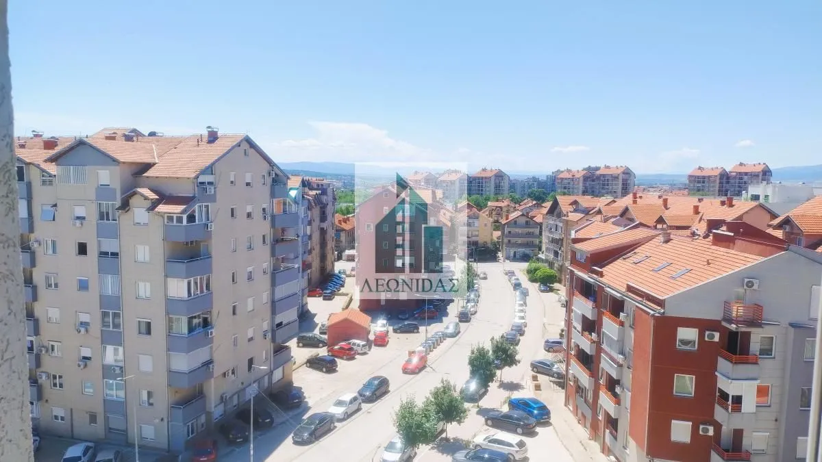 View from the window overlooking surrounding buildings and the city street.