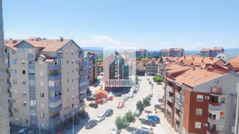 View from the window overlooking surrounding buildings and the city street. - image 9