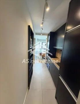 Modern kitchen with dark cabinetry and built-in appliances. - image 7