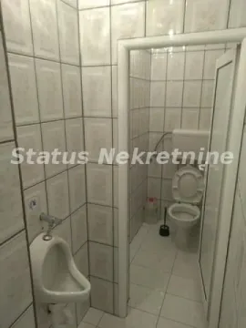 Smaller tiled bathroom with a toilet and urinal. - image 8
