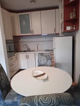 Kitchen with a dining table and white cabinets. - image 3