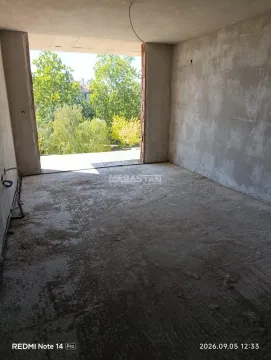 Unfinished room in grey phase of construction with a view of greenery. - image 2