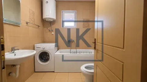 Bathroom equipped with a bathtub, washbasin, washing machine, and water heater. - image 5