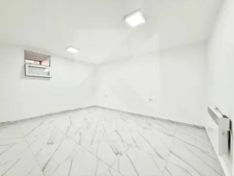 Empty room with white walls and tiled flooring. - image 5