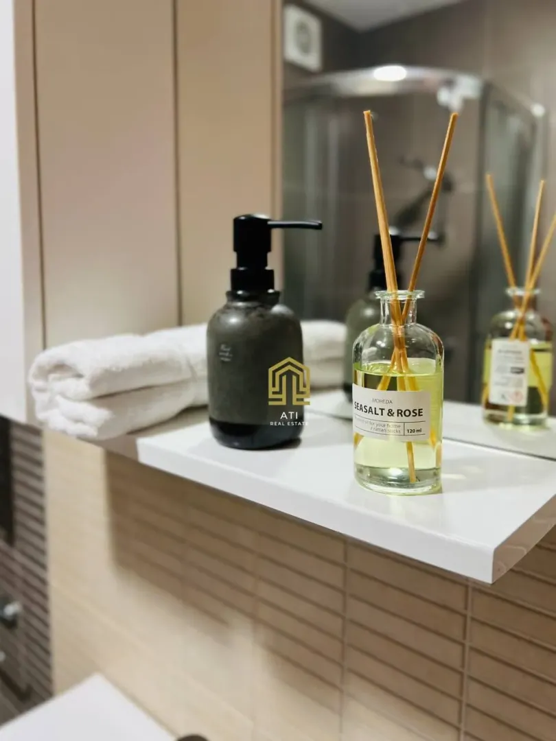 Detail with a shelf and cosmetics in the bathroom.