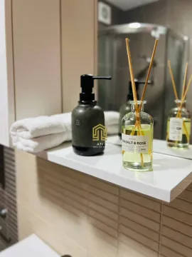 Detail with a shelf and cosmetics in the bathroom. - image 6