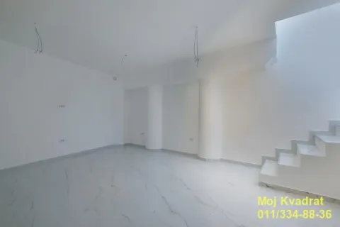 Empty room under construction with white ceramic tiles and a staircase. - image 8