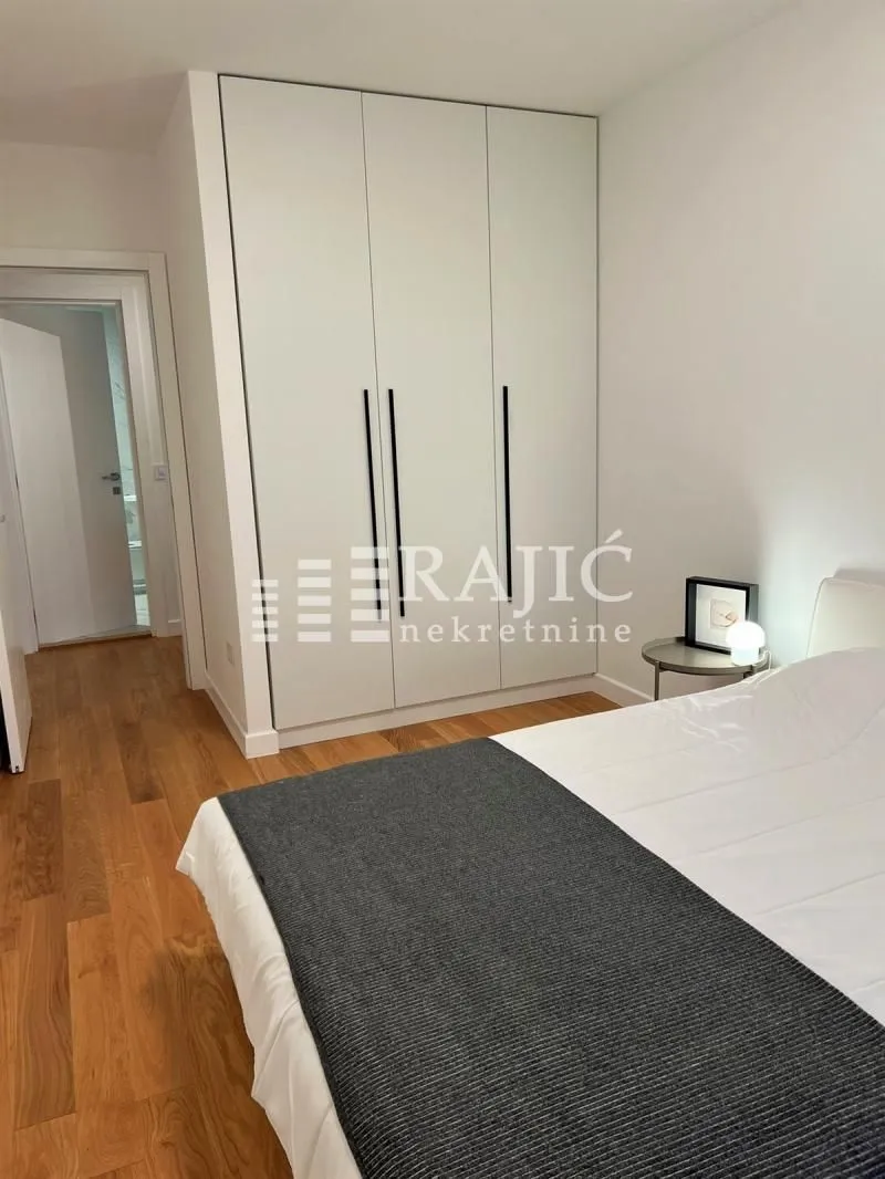 Bedroom with a large built-in wardrobe and a bed.