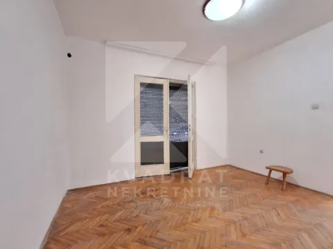 Empty room with parquet flooring and balcony doors. - image 16