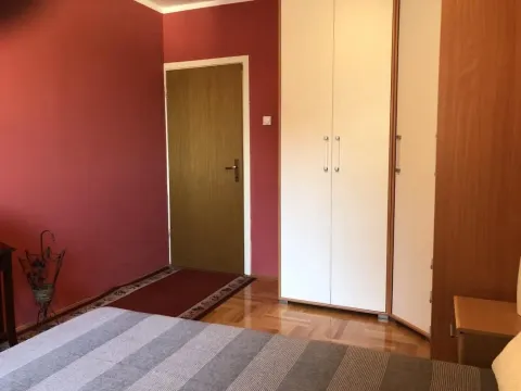 Bedroom with a bed, wardrobe, and red walls. - image 6