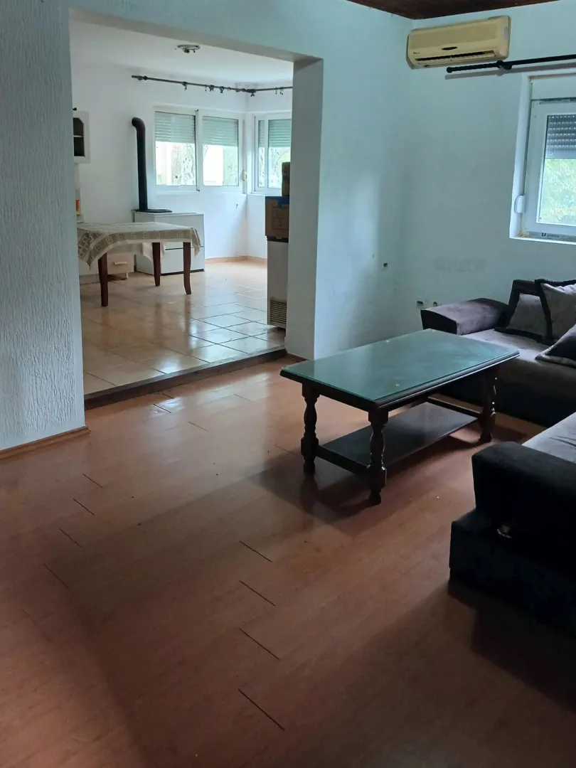 Living room with a sofa set and a view of the dining area.